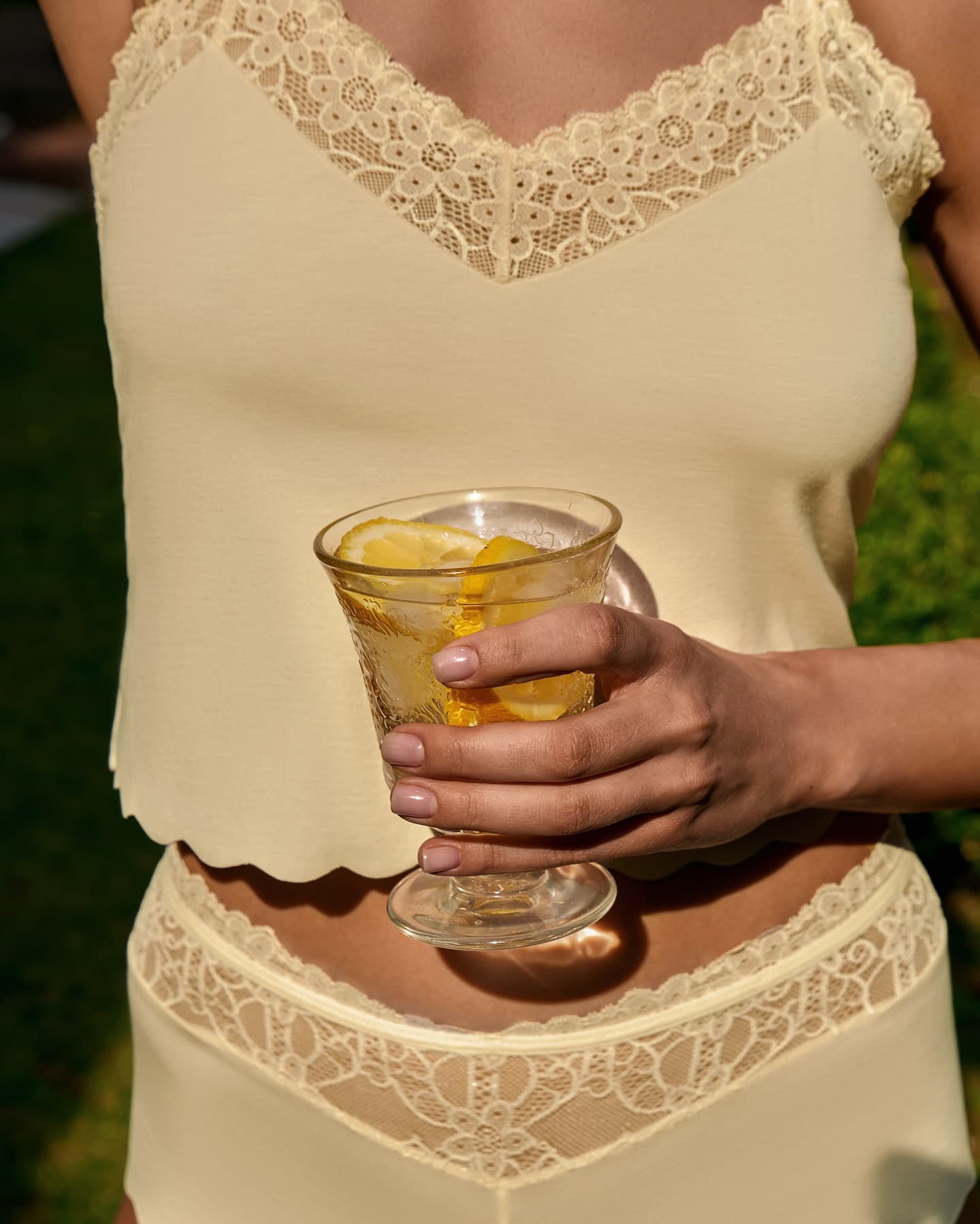 Limone camisole, a glass in hand